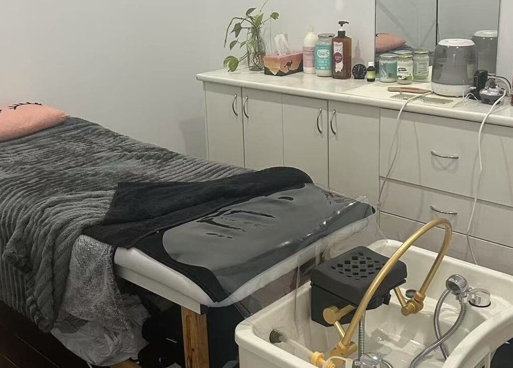Cozy treatment room at MB Luxury Spa Castletown, Hyde Park, Queensland, AU showcasing a plush massage table.
