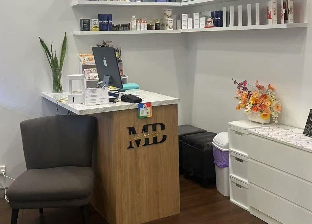 Reception area at MB Luxury Spa Castletown, Hyde Park, Queensland, AU with stylish decor and floral arrangement.