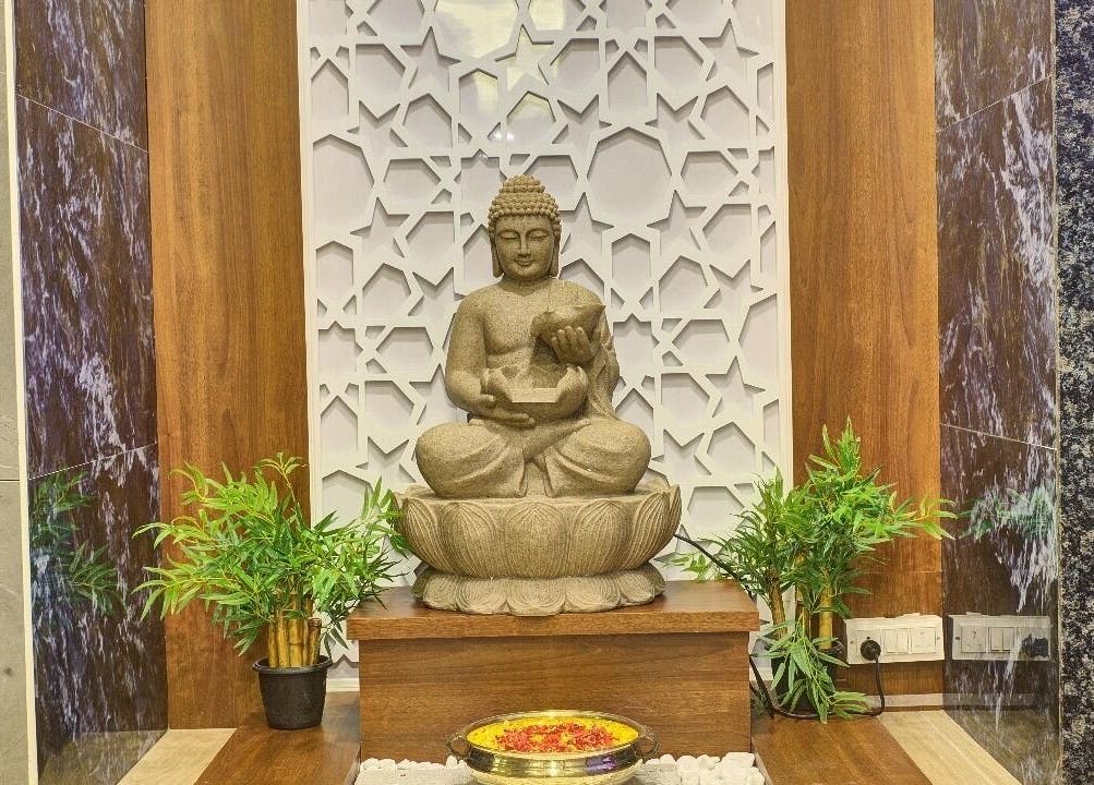 Buddha statue setting at Hasta Spa Tada, Tada, Andhra Pradesh, IN, promoting tranquility and relaxation.