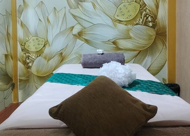 Relaxing massage room at Hasta Spa Besant Nagar, Chennai, Tamil Nadu, IN, featuring elegant floral decor.
