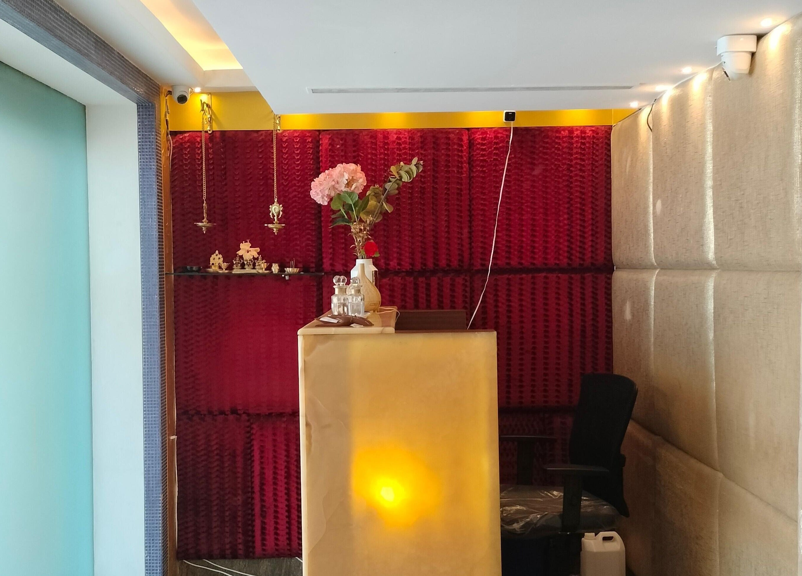 Reception desk at Hasta Spa Besant Nagar, Chennai, Tamil Nadu, IN with floral decor and ambient lighting.