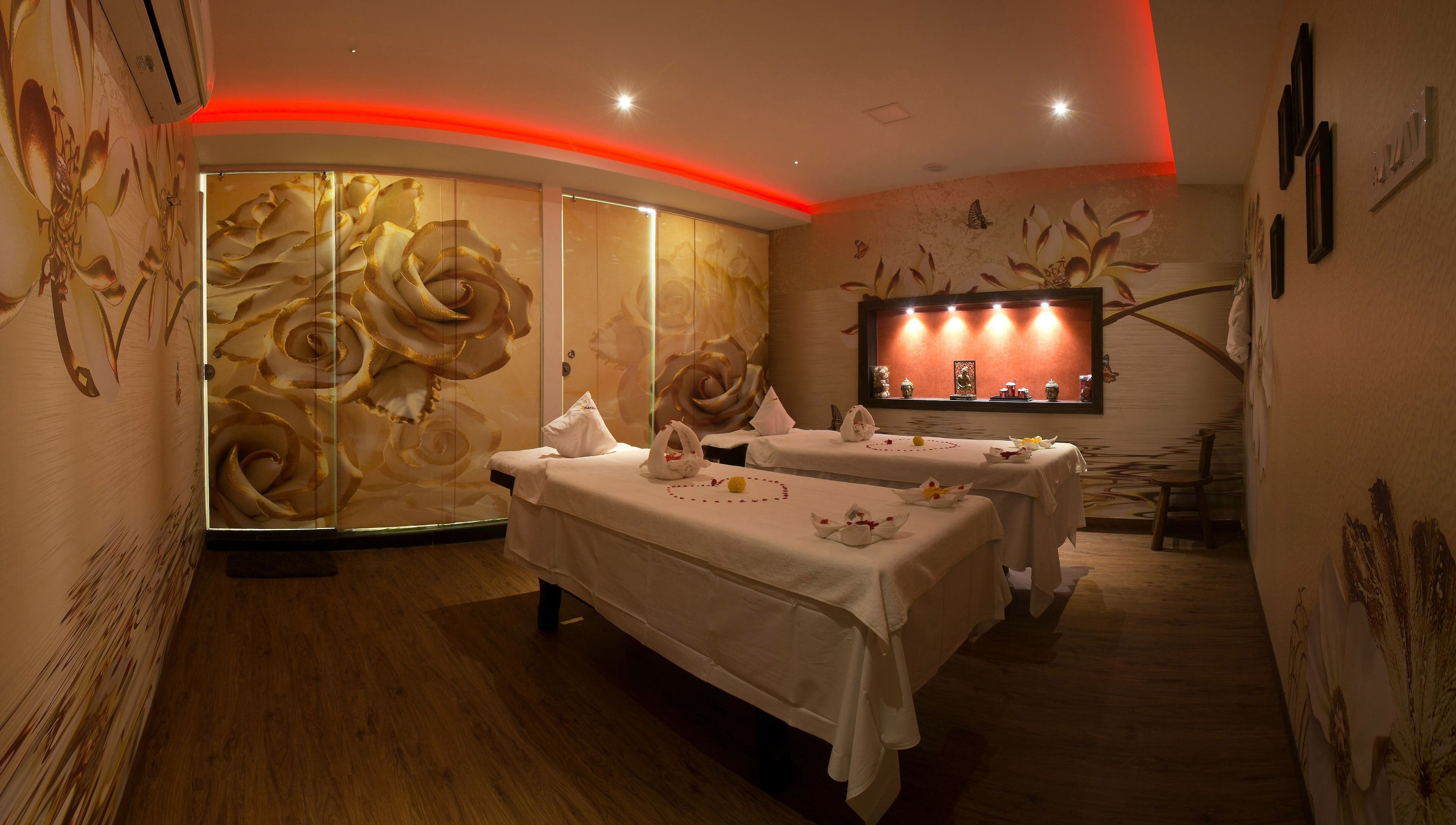 Luxurious massage room at Hasta Spa Virugambakkam, Chennai, Tamil Nadu, IN with floral decor and mood lighting.