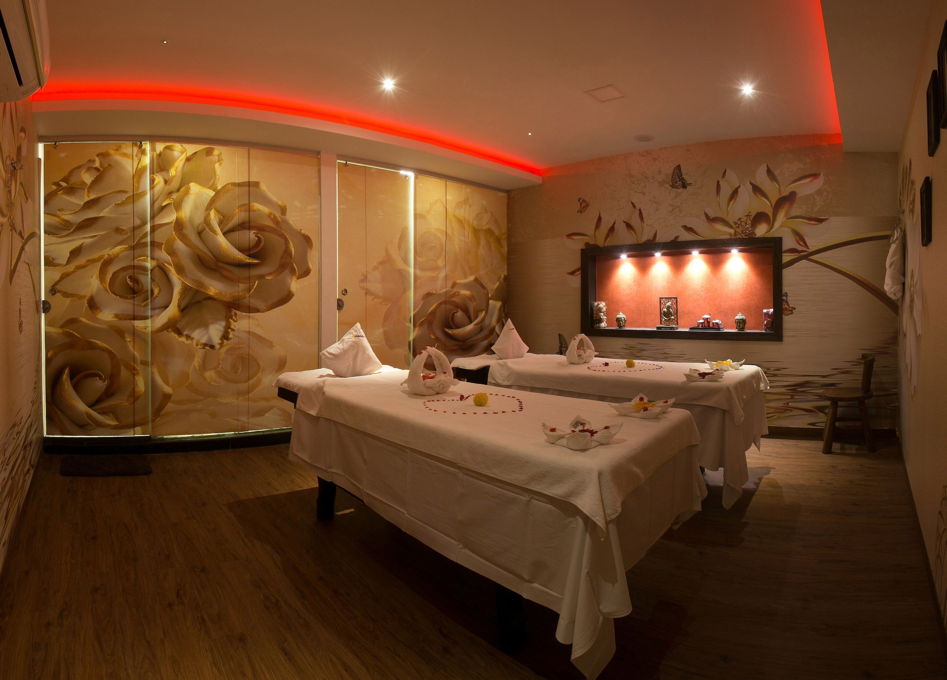 Luxurious massage room at Hasta Spa Virugambakkam, Chennai, Tamil Nadu, IN with floral decor and mood lighting.