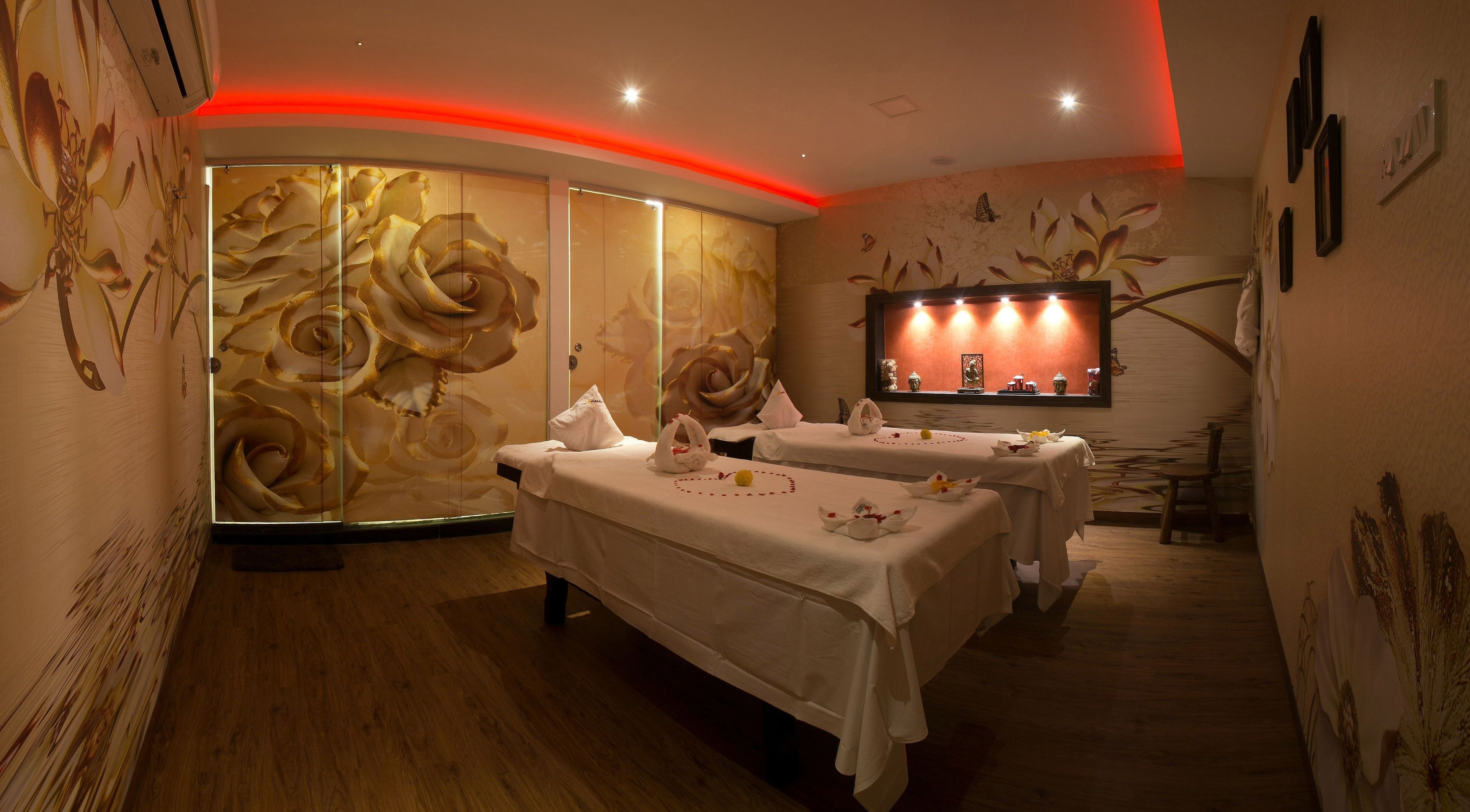 Luxurious massage room at Hasta Spa Virugambakkam, Chennai, Tamil Nadu, IN with floral decor and mood lighting.