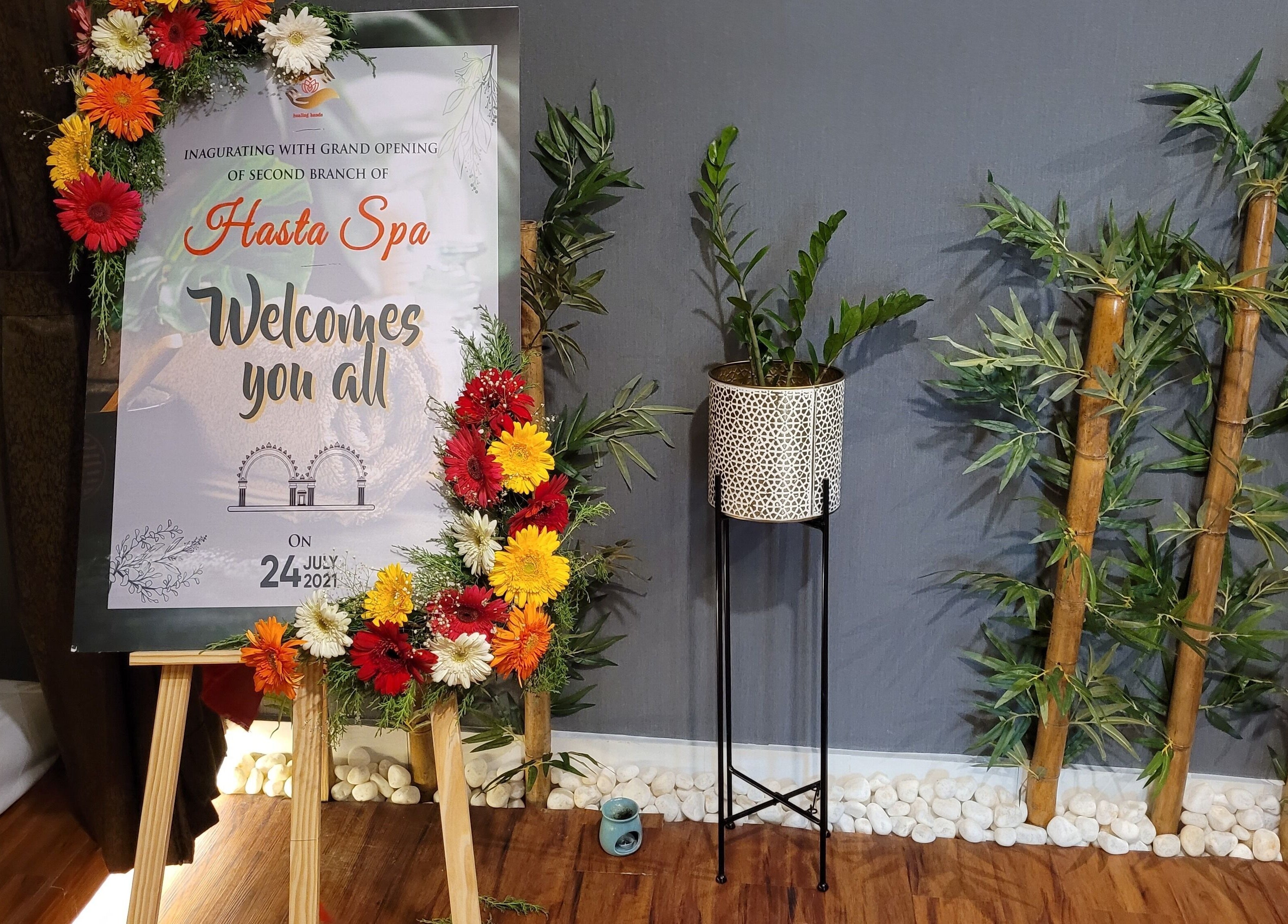 Grand opening welcome sign at Hasta Spa Anna Nagar, Chennai, Tamil Nadu, IN, adorned with colorful flowers.