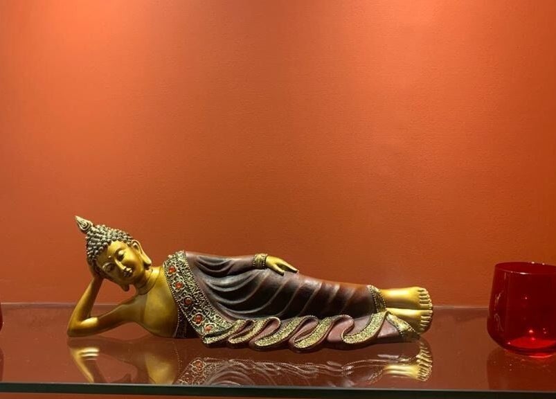 Elegant Buddha statue on glass shelf at Hasta Spa Anna Nagar, Chennai, Tamil Nadu, IN amidst calming decor.