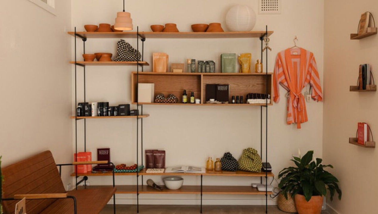 Shelf with wellness products and robe at Mesa Health & Wellness Studio in Freshwater, AU.