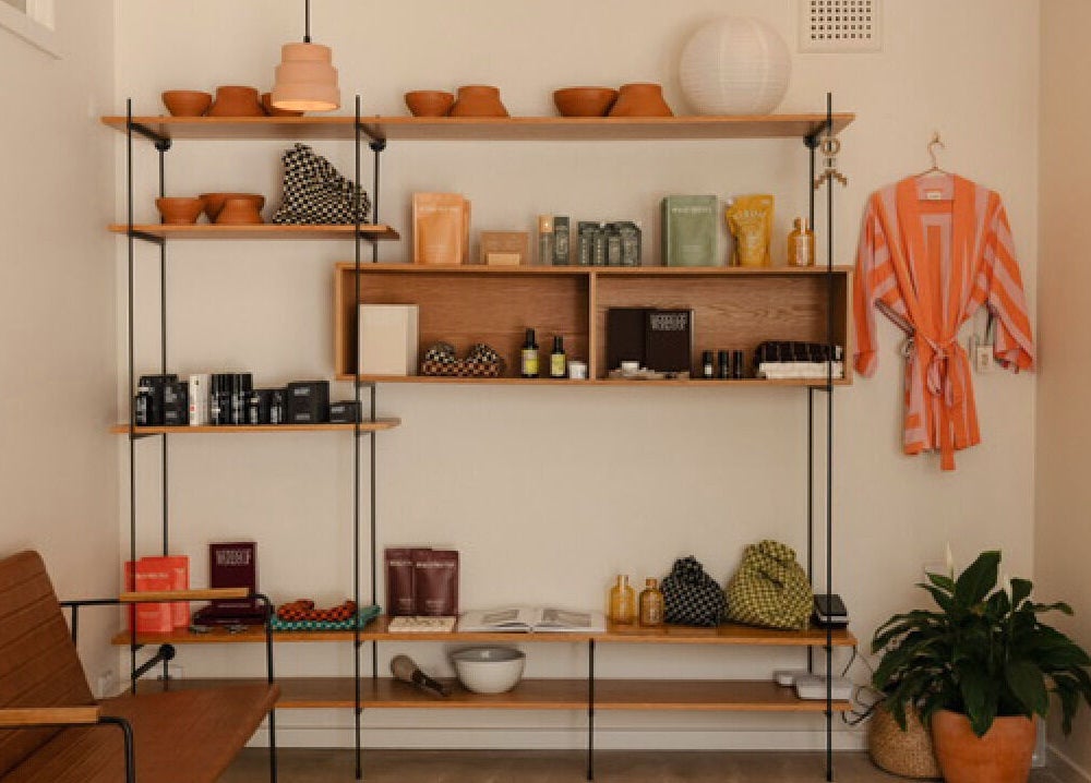 Shelf with wellness products and robe at Mesa Health & Wellness Studio in Freshwater, AU.