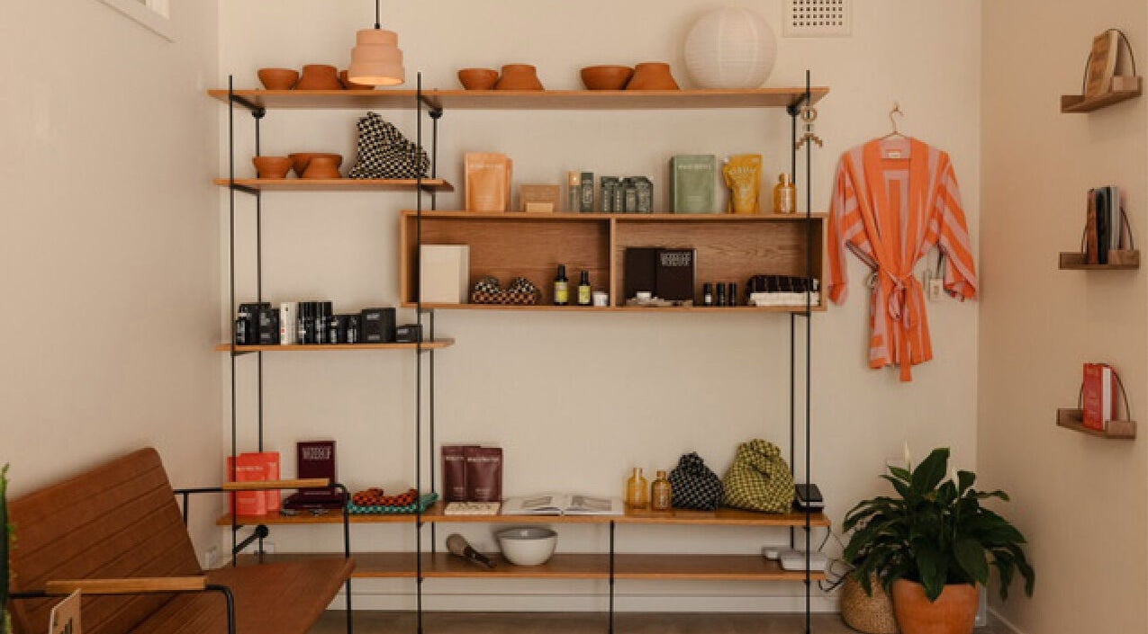 Shelf with wellness products and robe at Mesa Health & Wellness Studio in Freshwater, AU.