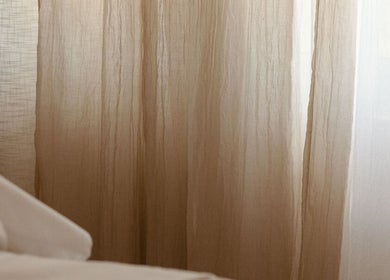 Soothing beige curtains at Mesa Health & Wellness Studio in Freshwater, AU, creating a calm atmosphere.