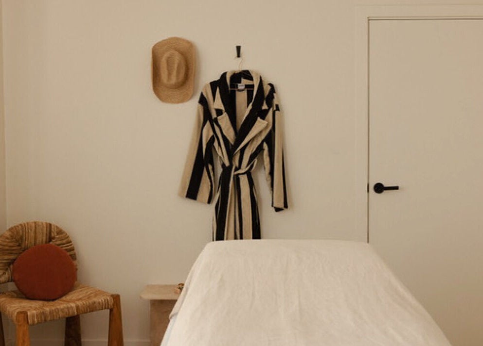 Cozy massage room with robe at Mesa Health & Wellness Studio, Freshwater, AU.
