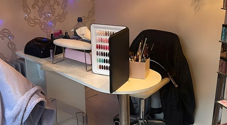 Stylish nail station at Aurora Beauty in Redditch, England, GB, showcasing tools and vibrant nail polish display.