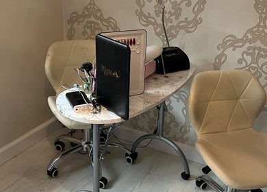 Cozy nail station setup at Aurora Beauty, Redditch, England, GB, featuring elegant chairs and tools.