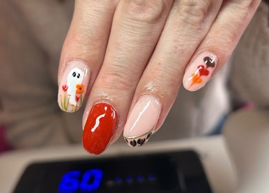 Stylish floral and ghost nail art at Aurora Beauty, Redditch, England, GB, featuring vibrant colors.