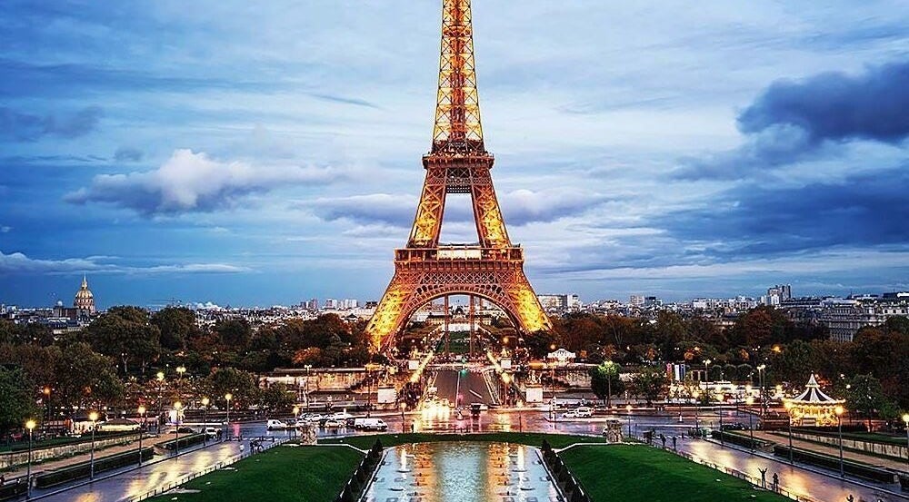 The Eiffel Tower illuminated at dusk in Paris, viewed beautifully from Worsley, England, GB.