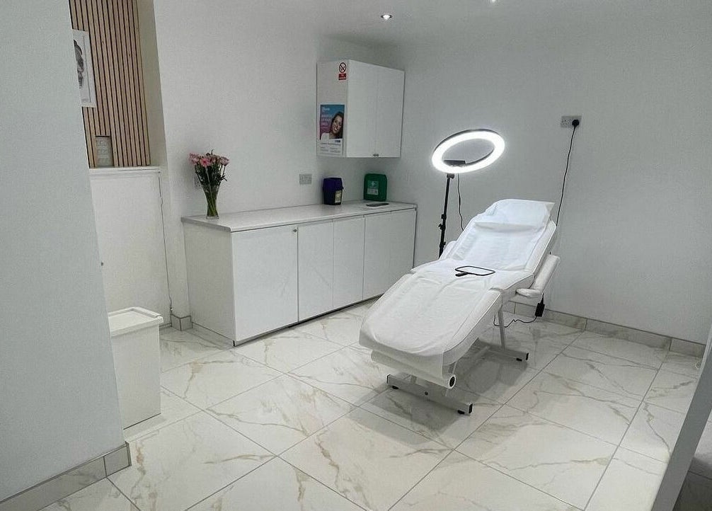 Bright, serene treatment room at The Sculpted Clinic in Towcester, England, GB with a modern aesthetic couch.