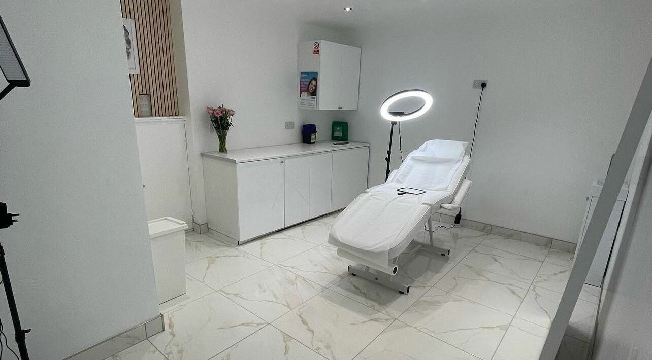 Bright, serene treatment room at The Sculpted Clinic in Towcester, England, GB with a modern aesthetic couch.