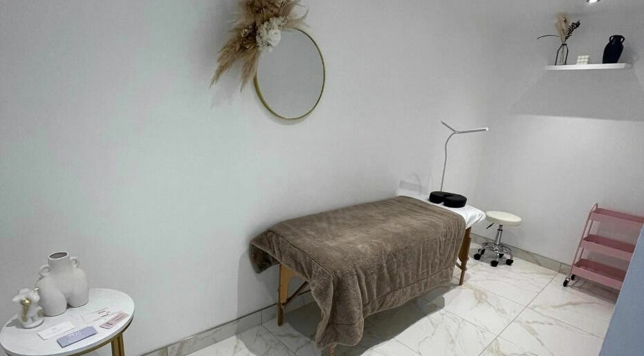 Tranquil therapy room at The Sculpted Clinic, Towcester, England, GB with a cozy treatment table.