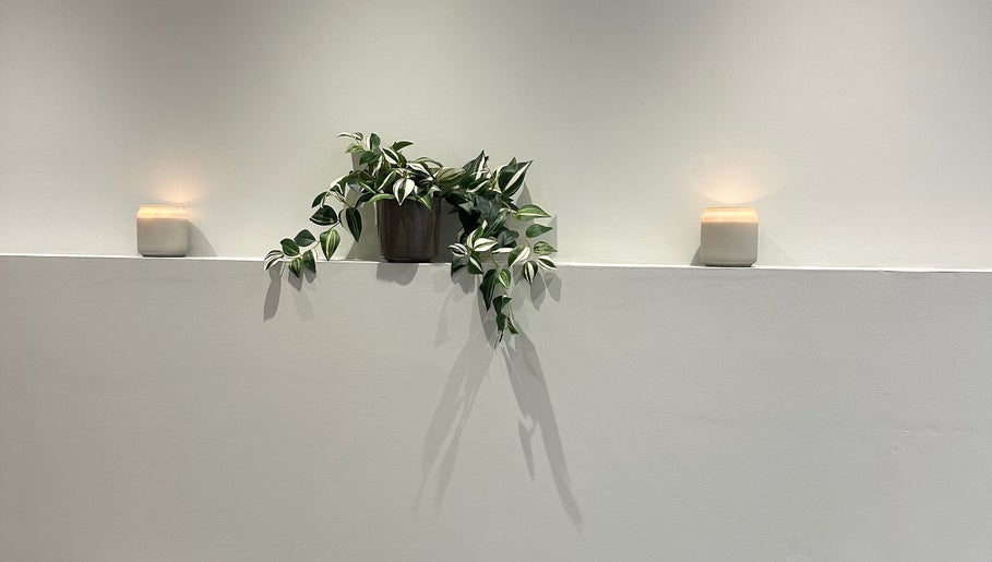 Peaceful interior at IB Beauty & Aesthetics, Newton-le-Willows, with candles and greenery for ambience.
