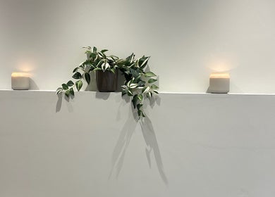 Peaceful interior at IB Beauty & Aesthetics, Newton-le-Willows, with candles and greenery for ambience.