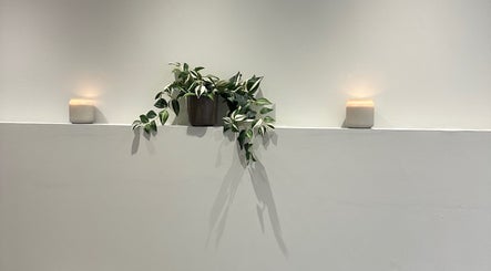 Peaceful interior at IB Beauty & Aesthetics, Newton-le-Willows, with candles and greenery for ambience.