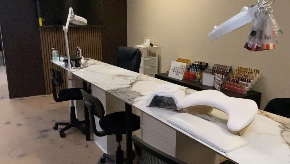 Modern nail station at Sculpted by Perla in Fort Mohave, Arizona, US, showcasing a stylish and professional setup.