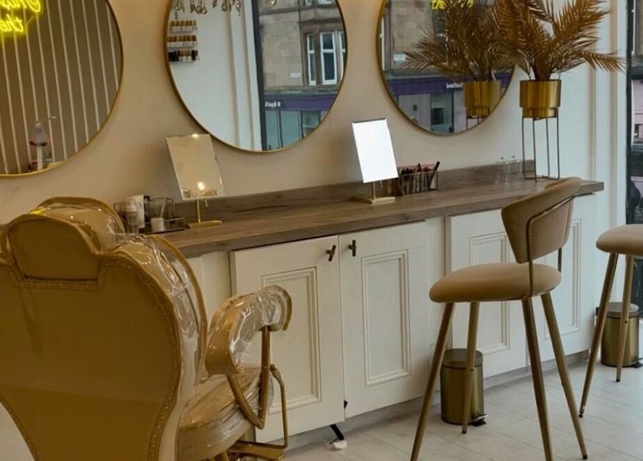 Stylish interior of Dutchess Salon Glasgow, Glasgow, Scotland, GB with chic mirrors and plush seating.