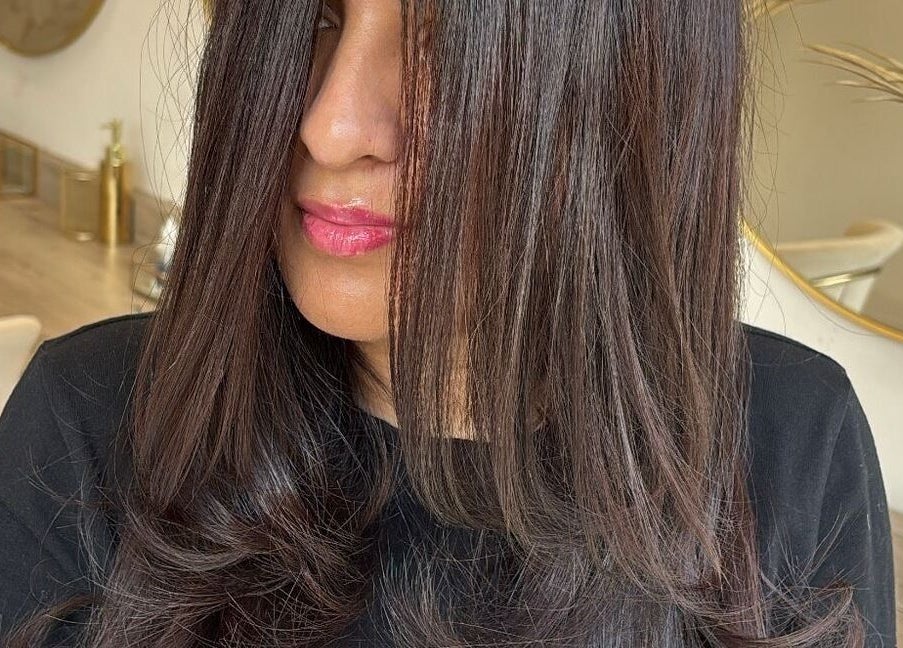 Stylish long brown hair styled at Dutchess Salon Glasgow, Scotland, GB, showcasing sleek and glossy finish.