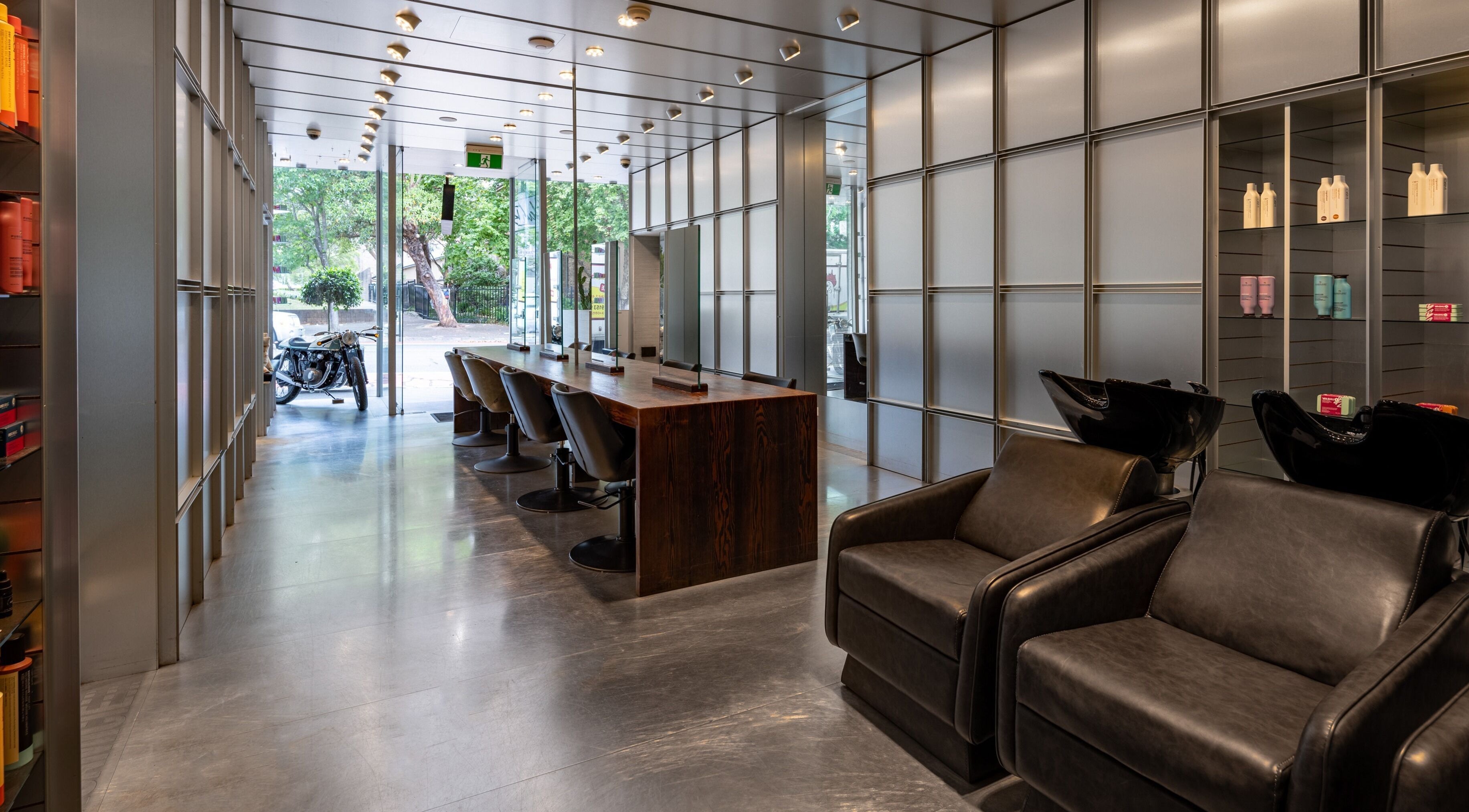 Modern interior of Alan Buki Hair in Paddington, New South Wales, AU, showcasing stylish chairs and sleek decor.