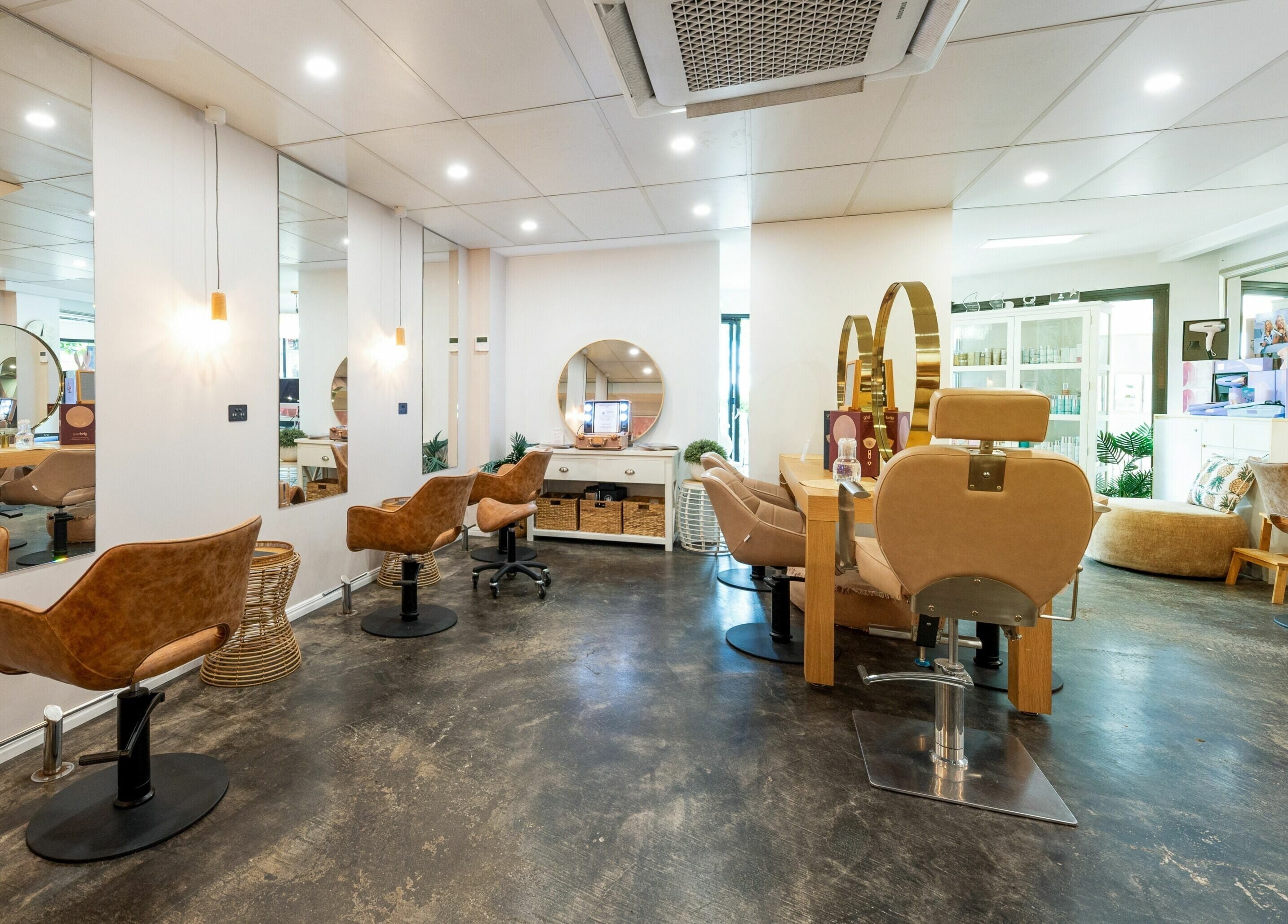 Modern interior of Style Mecha salon in Thorneside, Queensland, AU, showcasing stylish chairs and mirrors.