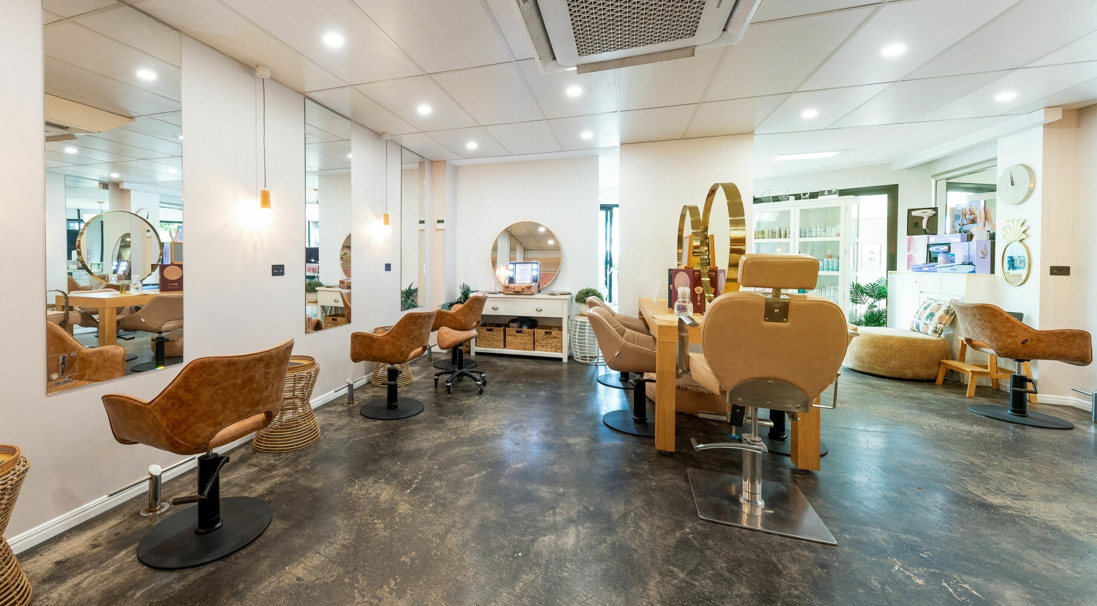 Modern interior of Style Mecha salon in Thorneside, Queensland, AU, showcasing stylish chairs and mirrors.