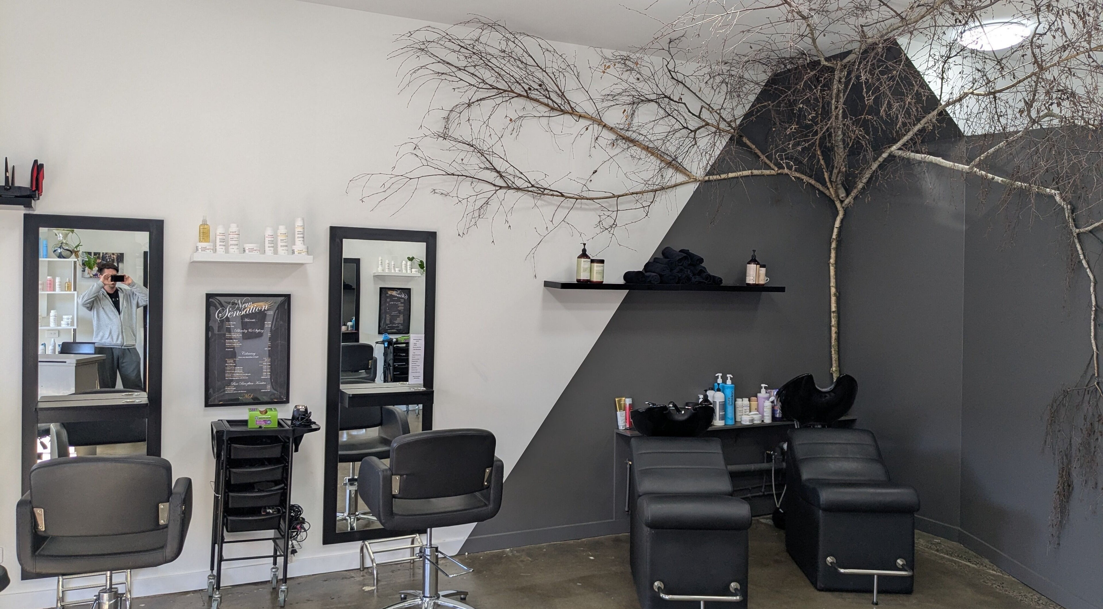 New Sensations Hairstyling in Melbourne, Victoria, AU features modern salon chairs and elegant decor.