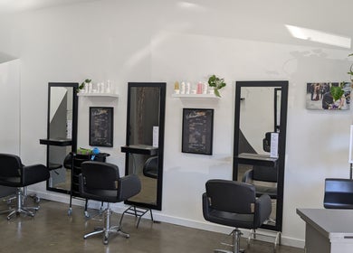 Interior of New Sensations Hairstyling salon, Melbourne, Victoria, AU showing sleek styling stations.
