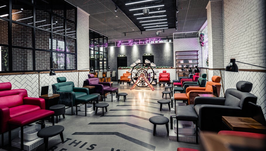 Stylish nail salon at We Nails Trident Grand Residence, Dubai, AE with colorful seating and modern decor.