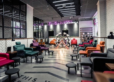 Stylish nail salon at We Nails Trident Grand Residence, Dubai, AE with colorful seating and modern decor.