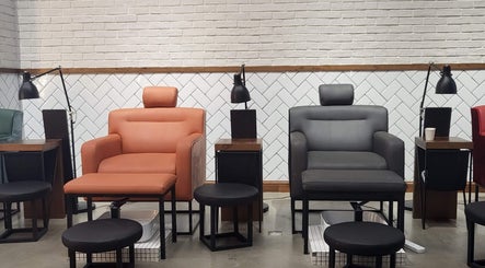 Comfortable nail salon chairs at We Nails Trident Grand Residence, Dubai, AE with stylish decor.