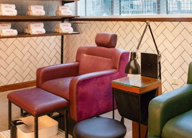 Luxurious pedicure seating at We Nails Trident Grand Residence, Dubai, AE, with plush chairs and modern decor.