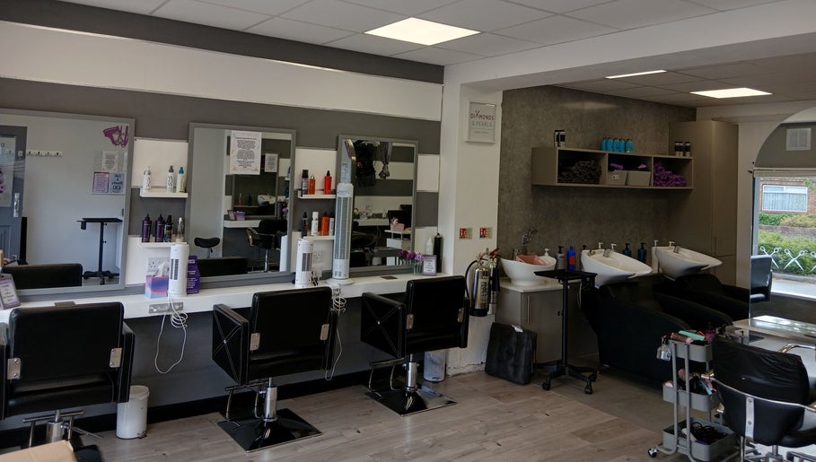 Interior of Diamonds and Pearls Hair Studio in Northfleet, England, GB with styling chairs and hair wash stations.
