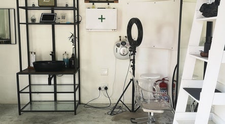 Sleek barber station at fiVe Hair Barber, Cape Town, Western Cape, ZA with a mirror, sink, and styling chair.
