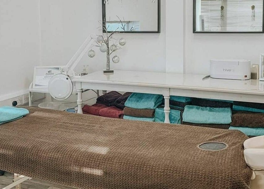 Relaxing therapy room at Remote Therapies, Shillingford, England, GB, featuring massage table and serene decor.