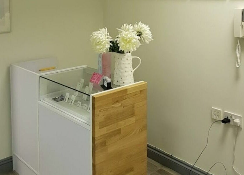 Elegant corner display at Remote Therapies, Shillingford, England, GB featuring a vase with flowers.