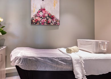 Serene treatment room at Revive Beauty Clinic, Padstow, New South Wales, AU, with a massage bed and floral decor.