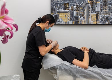 A beauty specialist at Revive Beauty Clinic, Padstow, New South Wales, AU, provides precision skincare treatment.