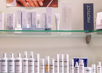 Revive Beauty Clinic Padstow showcases premium skincare products on a sleek glass shelf.
