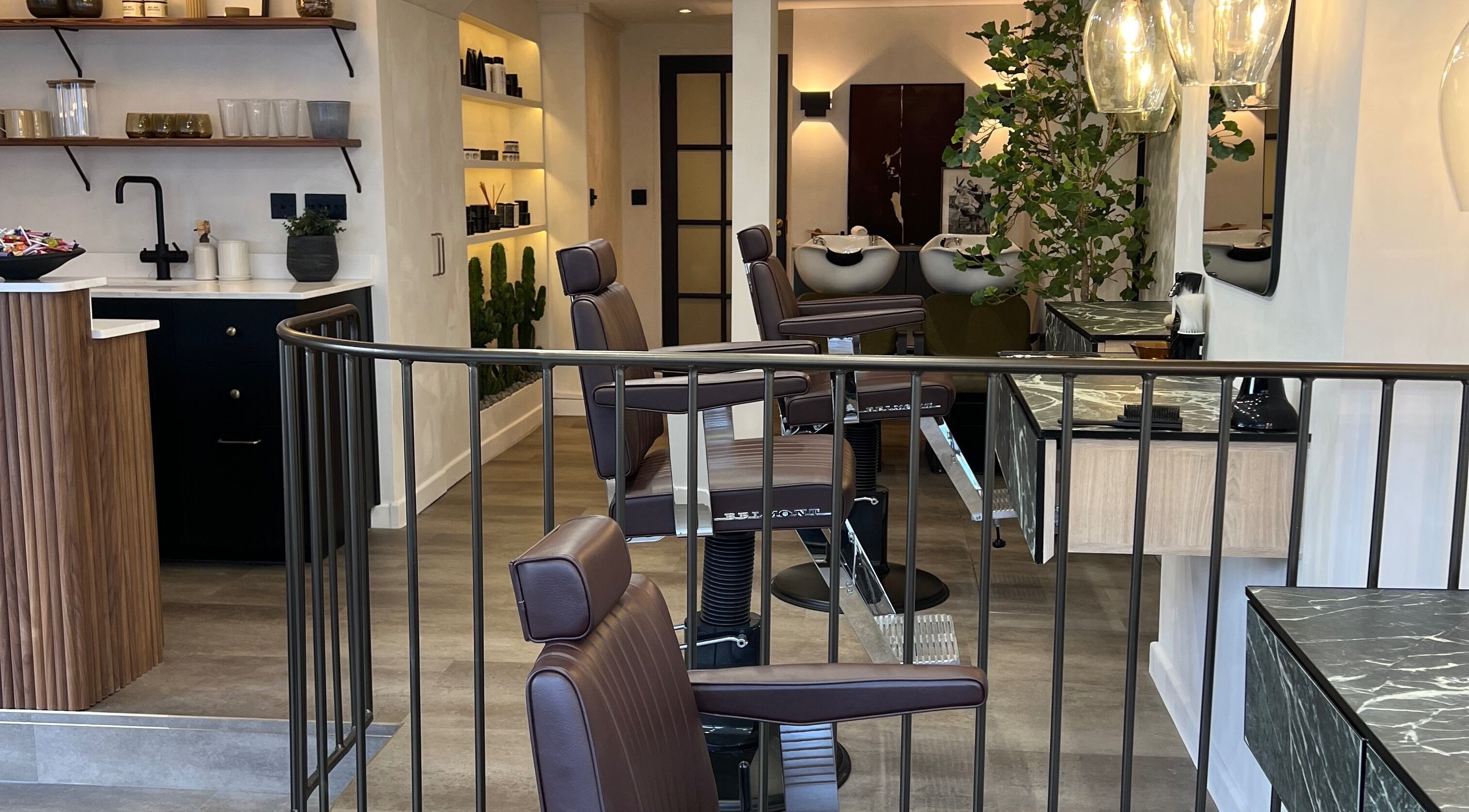 Modern interior of Bearded Dragon Barbers in Chelmsford, England, featuring stylish barber chairs and sleek design.
