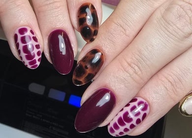 Stylish gel nail designs at Nails by Ashley in Bangor, Northern Ireland, GB incorporating bold patterns.
