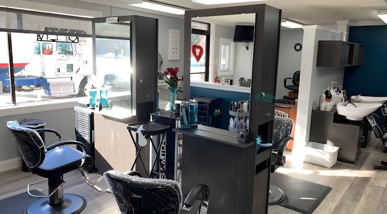 Modern salon interior at Hair By Jennifer Marie, Waterbury, Connecticut, US, featuring stylish chairs and decor.