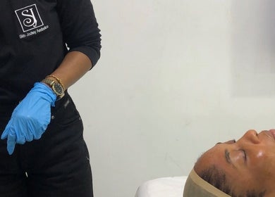 Professional skin treatment at Skinjockey, Lagos, Lagos, NG, showcasing a client in a serene spa setting.