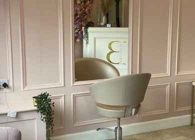 Elegant interior of Bellissima Lounge in Kirkcaldy, Scotland, GB, featuring a plush salon chair and a decorative mirror.