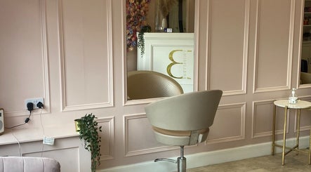 Elegant interior of Bellissima Lounge in Kirkcaldy, Scotland, GB, featuring a plush salon chair and a decorative mirror.